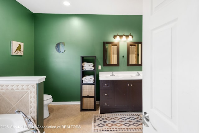 14747 Forest Hill Rd, Grand Ledge, MI 48837 - bathroom featuring double vanity, a garden tub, tile patterned floors, and recessed lighting