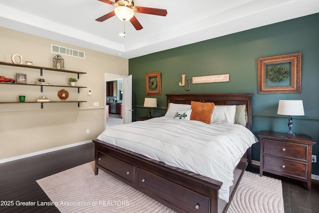 14747 Forest Hill Rd, Grand Ledge, MI 48837 - bedroom with wood finished floors, a tray ceiling, and ceiling fan