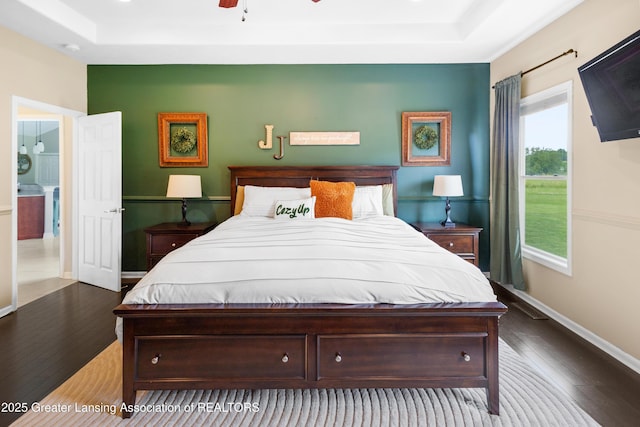 14747 Forest Hill Rd, Grand Ledge, MI 48837 - bedroom featuring a tray ceiling and hardwood / wood-style floors
