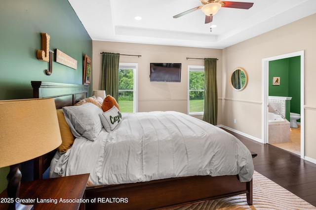 14747 Forest Hill Rd, Grand Ledge, MI 48837 - bedroom with hardwood / wood-style flooring, a tray ceiling, recessed lighting, ensuite bath, and ceiling fan