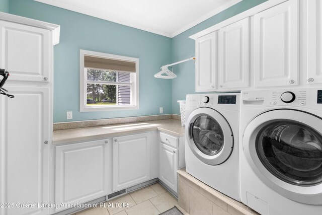 14747 Forest Hill Rd, Grand Ledge, MI 48837 - washroom featuring washer and clothes dryer, cabinet space, ornamental molding, and light tile patterned floors