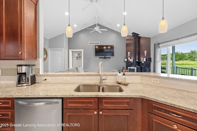 14747 Forest Hill Rd, Grand Ledge, MI 48837 - kitchen with stainless steel dishwasher, tasteful backsplash, vaulted ceiling, ceiling fan, and light stone countertops