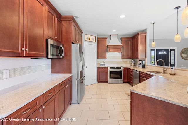 14747 Forest Hill Rd, Grand Ledge, MI 48837 - kitchen with stainless steel appliances, premium range hood, light stone counters, decorative backsplash, and recessed lighting