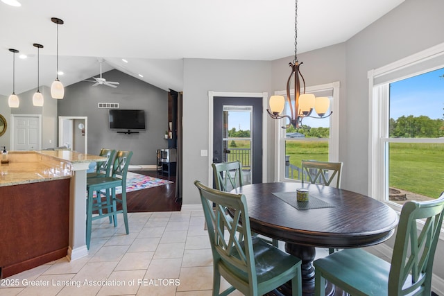 14747 Forest Hill Rd, Grand Ledge, MI 48837 - dining room with healthy amount of natural light, vaulted ceiling, a chandelier, ceiling fan, and light tile patterned flooring