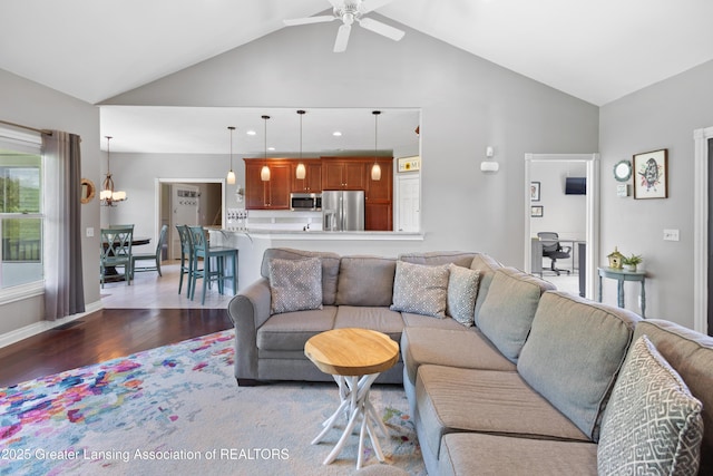 14747 Forest Hill Rd, Grand Ledge, MI 48837 - living room featuring light wood-style floors, ceiling fan, a chandelier, and high vaulted ceiling
