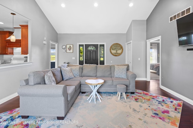 14747 Forest Hill Rd, Grand Ledge, MI 48837 - living room featuring plenty of natural light, wood finished floors, high vaulted ceiling, and recessed lighting
