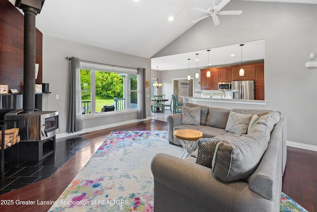 14747 Forest Hill Rd, Grand Ledge, MI 48837 - living room with ceiling fan, recessed lighting, a wood stove, high vaulted ceiling, and dark wood finished floors