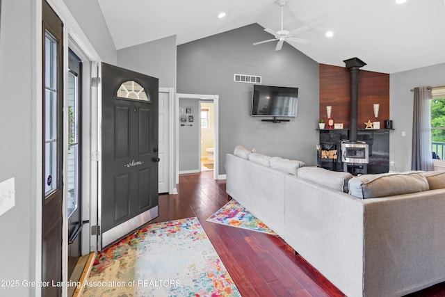 14747 Forest Hill Rd, Grand Ledge, MI 48837 - living room featuring a wood stove, ceiling fan, hardwood / wood-style floors, high vaulted ceiling, and recessed lighting