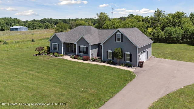 14747 Forest Hill Rd, Grand Ledge, MI 48837 - view of front facade with asphalt driveway, a front lawn, and a garage