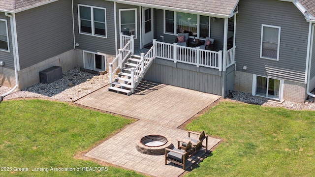 14747 Forest Hill Rd, Grand Ledge, MI 48837 - back of house featuring a lawn, a patio, and an outdoor living space with a fire pit