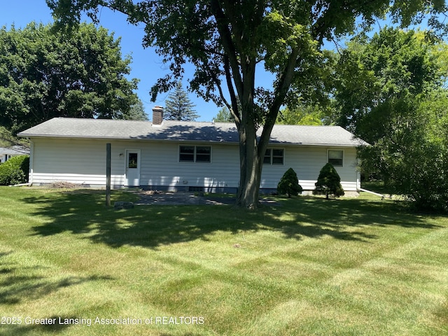 3931 Berry Ridge Dr, Holt, MI 48842 - back of property featuring a lawn and a chimney