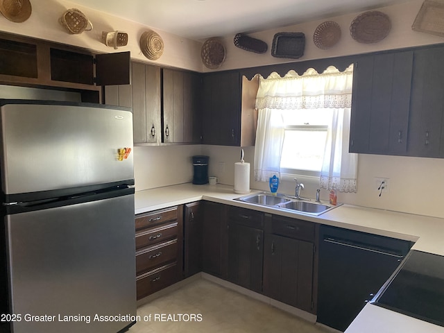 3931 Berry Ridge Dr, Holt, MI 48842 - kitchen with freestanding refrigerator, light countertops, and cooktop