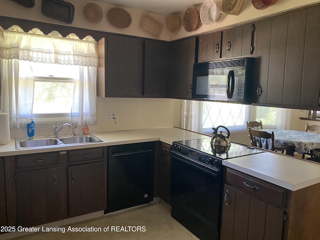 3931 Berry Ridge Dr, Holt, MI 48842 - kitchen with black appliances, healthy amount of natural light, and light countertops