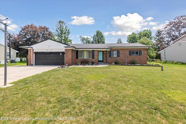 8713 Wintergreen St, Lansing, MI 48917 - single story home with an attached garage, concrete driveway, brick siding, and a front lawn