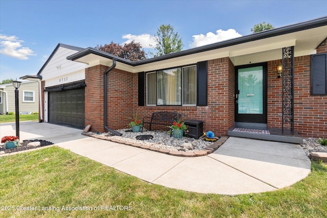 8713 Wintergreen St, Lansing, MI 48917 - view of front of home with brick siding, an attached garage, and driveway