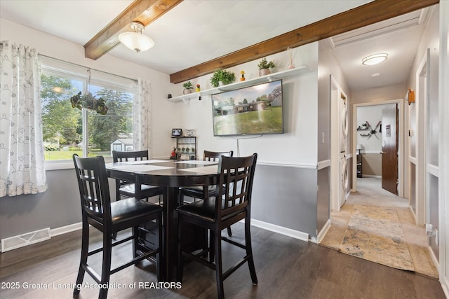8713 Wintergreen St, Lansing, MI 48917 - dining area with wood finished floors and beamed ceiling