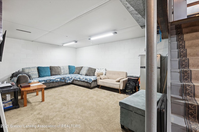 8713 Wintergreen St, Lansing, MI 48917 - living room with concrete block wall and carpet floors