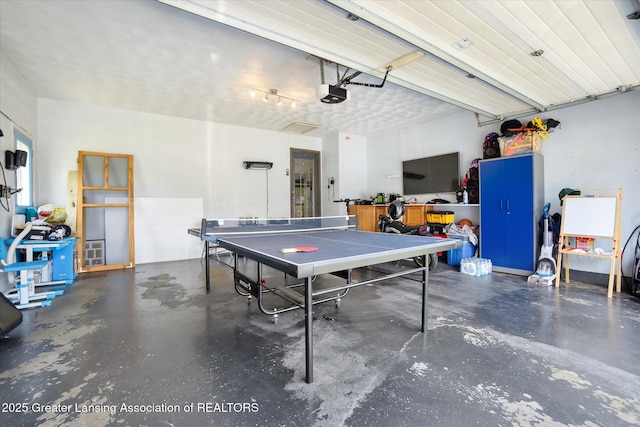 8713 Wintergreen St, Lansing, MI 48917 - playroom featuring concrete floors and a garage