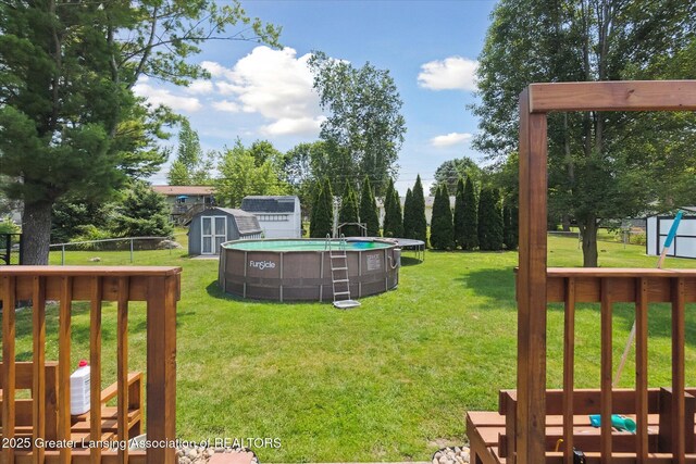 8713 Wintergreen St, Lansing, MI 48917 - view of yard featuring a storage shed and an outdoor pool