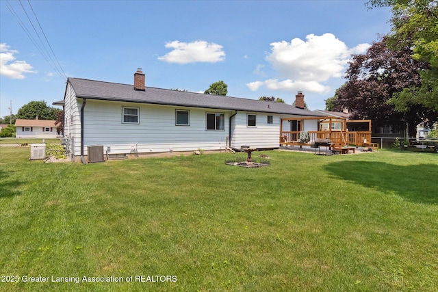 8713 Wintergreen St, Lansing, MI 48917 - back of property with a chimney and a deck