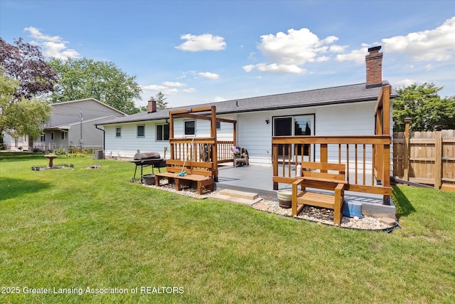 8713 Wintergreen St, Lansing, MI 48917 - back of property with a deck and a chimney