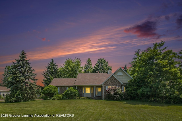 6875 W Howe Rd, Dewitt, MI 48820 - view of front of property with a front lawn and a chimney
