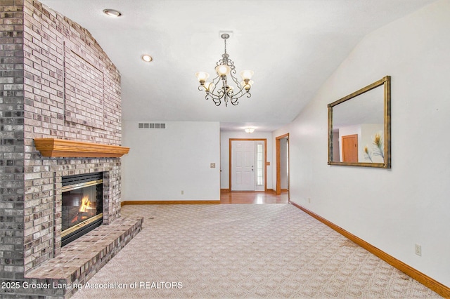 6875 W Howe Rd, Dewitt, MI 48820 - unfurnished living room with carpet flooring, a chandelier, a brick fireplace, lofted ceiling, and recessed lighting