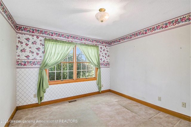 6875 W Howe Rd, Dewitt, MI 48820 - carpeted empty room featuring baseboards and wallpapered walls