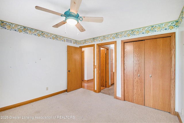 6875 W Howe Rd, Dewitt, MI 48820 - unfurnished bedroom with carpet floors, a closet, and a ceiling fan