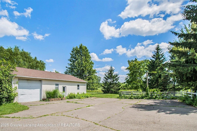 6875 W Howe Rd, Dewitt, MI 48820 - garage featuring asphalt driveway
