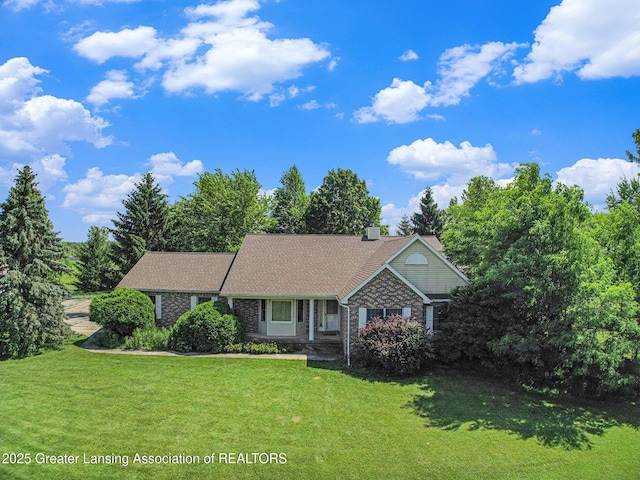 6875 W Howe Rd, Dewitt, MI 48820 - view of front of property with a front yard and brick siding