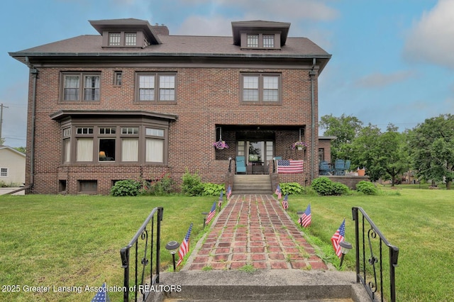 502 S Main St, Eaton Rapids, MI 48827 - view of front of house featuring brick siding and a front yard