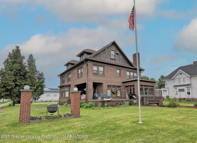 502 S Main St, Eaton Rapids, MI 48827 - rear view of property featuring a lawn and brick siding