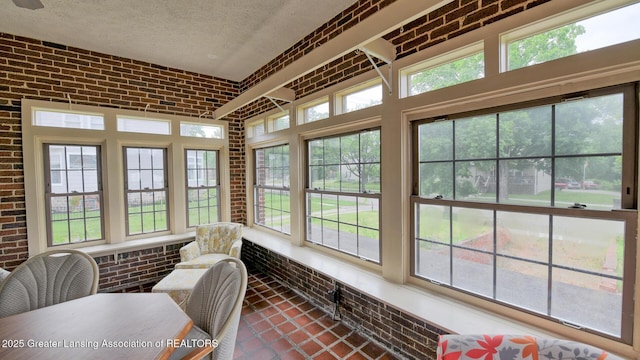 502 S Main St, Eaton Rapids, MI 48827 - sunroom featuring brick wall, a textured ceiling, and plenty of natural light