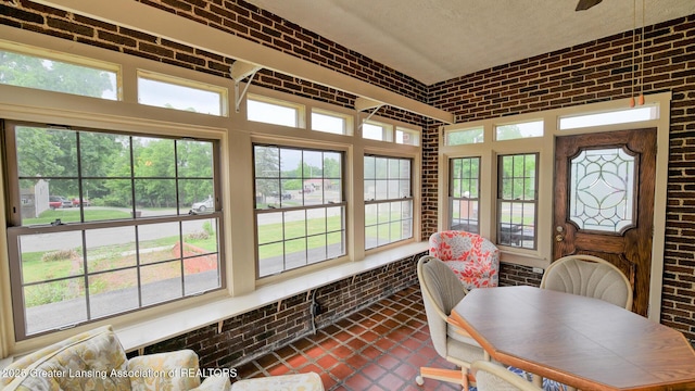 502 S Main St, Eaton Rapids, MI 48827 - sunroom featuring brick wall, healthy amount of natural light, tile patterned floors, and a textured ceiling