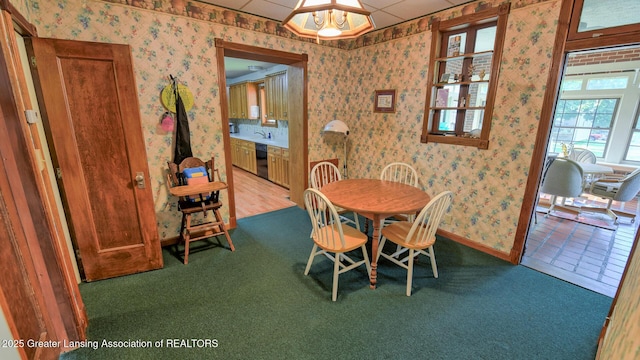 502 S Main St, Eaton Rapids, MI 48827 - carpeted dining space with wallpapered walls and baseboards