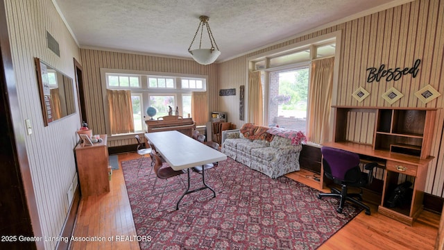502 S Main St, Eaton Rapids, MI 48827 - office featuring crown molding, hardwood / wood-style flooring, a textured ceiling, wallpapered walls, and plenty of natural light