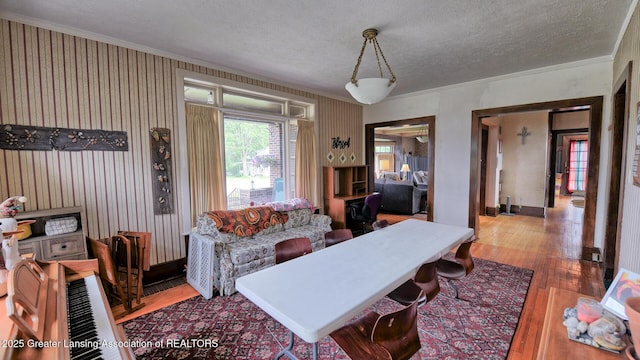 502 S Main St, Eaton Rapids, MI 48827 - living area with hardwood / wood-style floors, a textured ceiling, and crown molding