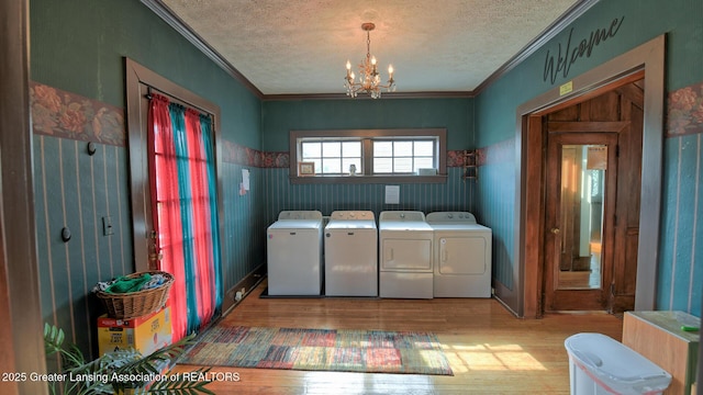 502 S Main St, Eaton Rapids, MI 48827 - laundry room with separate washer and dryer, a textured ceiling, wood finished floors, crown molding, and a chandelier