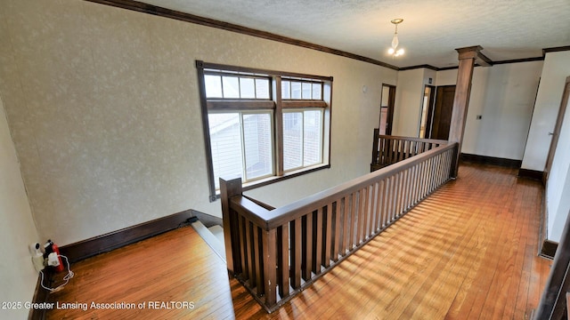 502 S Main St, Eaton Rapids, MI 48827 - hall featuring an upstairs landing, wood-type flooring, crown molding, plenty of natural light, and a textured wall