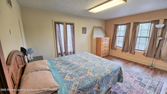 502 S Main St, Eaton Rapids, MI 48827 - bedroom featuring wood finished floors and a textured ceiling
