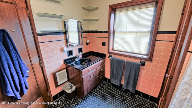 502 S Main St, Eaton Rapids, MI 48827 - bathroom featuring tile walls, vanity, tile patterned floors, and wainscoting
