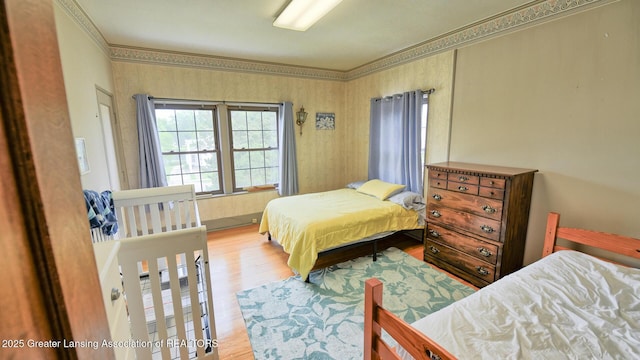502 S Main St, Eaton Rapids, MI 48827 - bedroom featuring wood finished floors and crown molding