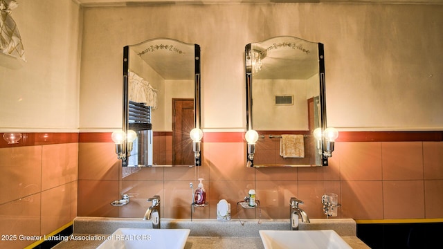 502 S Main St, Eaton Rapids, MI 48827 - bathroom featuring tasteful backsplash, tile walls, and vanity