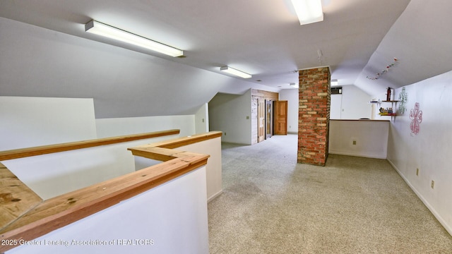 502 S Main St, Eaton Rapids, MI 48827 - additional living space featuring decorative columns, lofted ceiling, and carpet flooring