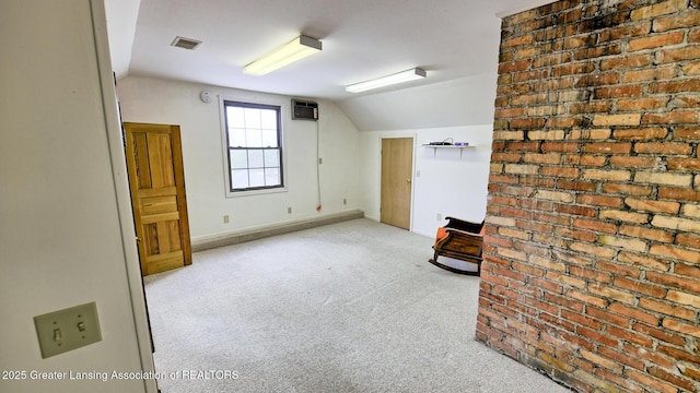 502 S Main St, Eaton Rapids, MI 48827 - bonus room featuring vaulted ceiling, carpet flooring, and a wall mounted air conditioner
