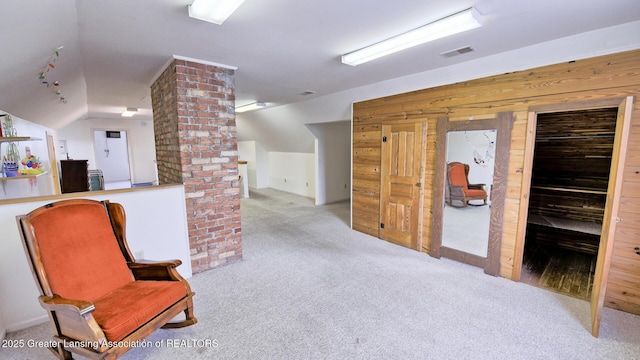 502 S Main St, Eaton Rapids, MI 48827 - sitting room with carpet flooring, lofted ceiling, decorative columns, and wood walls