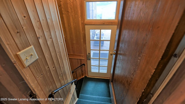 502 S Main St, Eaton Rapids, MI 48827 - doorway to outside featuring wood walls, carpet, and stairway