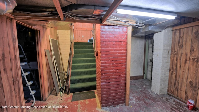 502 S Main St, Eaton Rapids, MI 48827 - unfinished below grade area featuring wood walls and stairway
