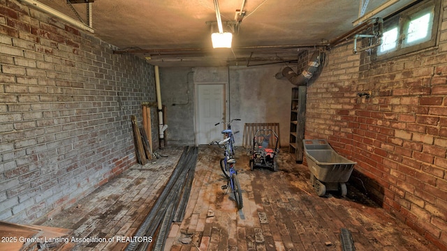 502 S Main St, Eaton Rapids, MI 48827 - basement featuring a garage and brick wall